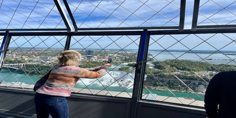 Visitor taking a photo of Niagara Falls from the Skylon Tower observation deck