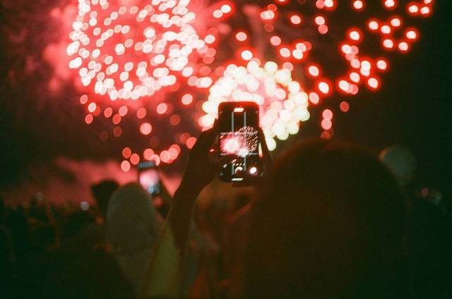Visitors taking photos of fireworks over Niagara Falls.
