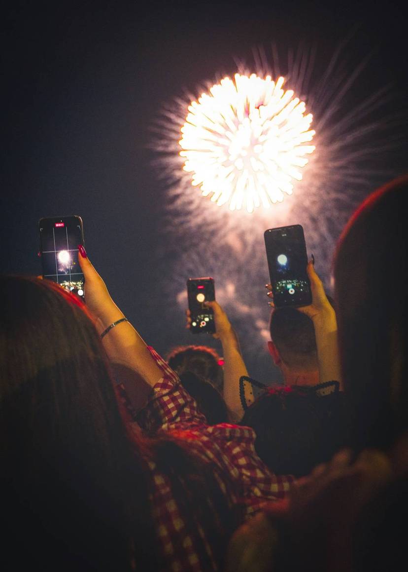 Visitors capturing fireworks over Niagara Falls.