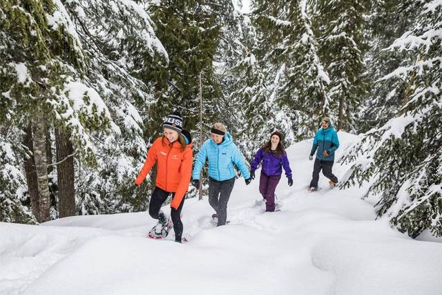 A group of friends snow shoeing at Grouse Mountain