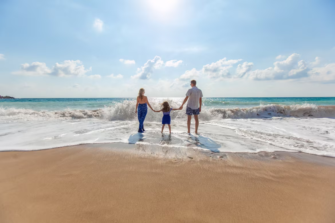 Family hand in hand at beach